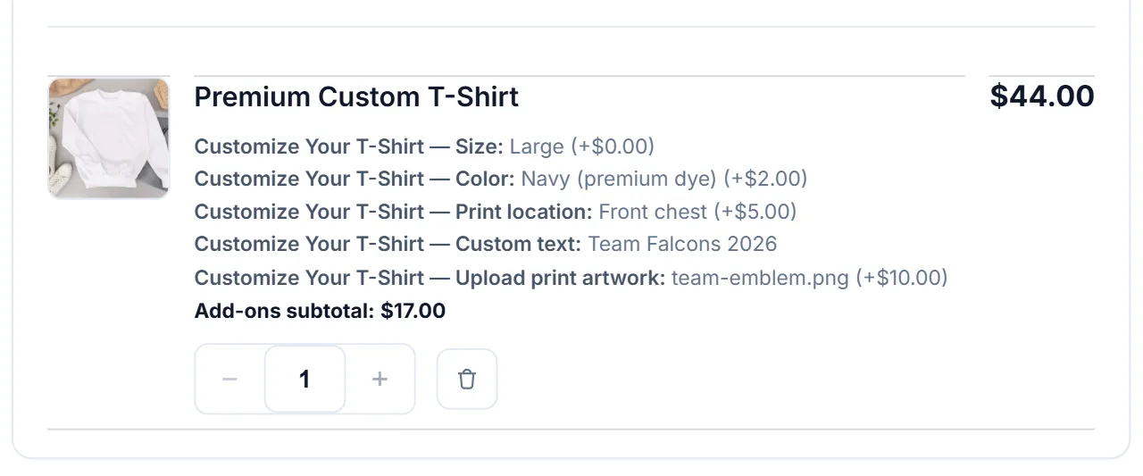 Cart line for a Premium Custom T-Shirt listing size, Navy color, Front chest print, custom text, the uploaded team-emblem.png file, and a $17.00 add-ons subtotal